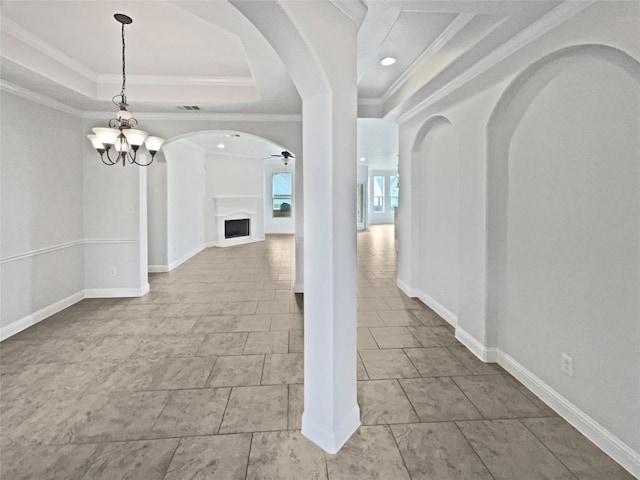 1985 Canyon Sage Path, Round Rock, TX 78665 - hall featuring a tray ceiling, ornamental molding, a chandelier, and arched walkways