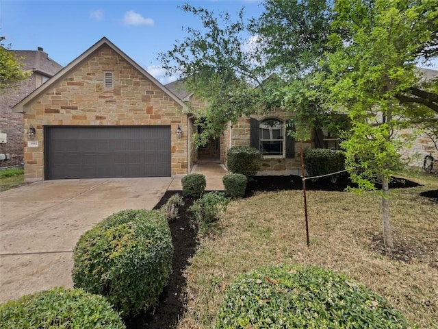 1985 Canyon Sage Path, Round Rock, TX 78665 - view of front of property featuring an attached garage, driveway, and stone siding