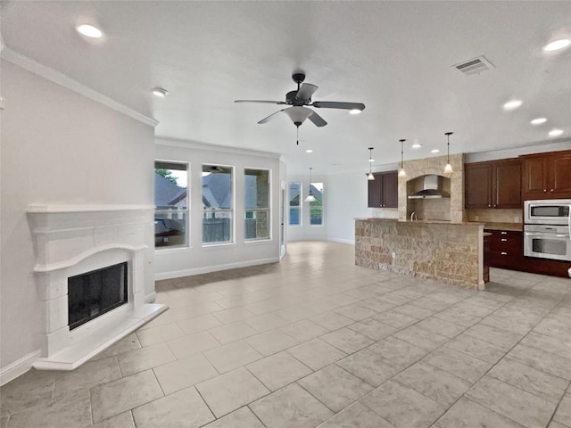 1985 Canyon Sage Path, Round Rock, TX 78665 - unfurnished living room featuring a fireplace with raised hearth, ornamental molding, recessed lighting, ceiling fan, and light tile patterned flooring