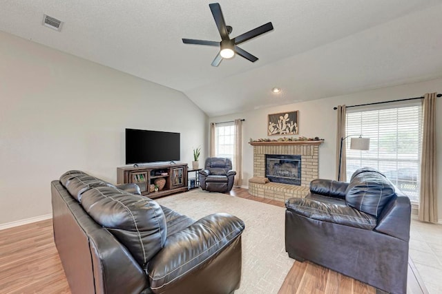 602 Totem Trl, Harker Heights, TX 76548 - living room featuring a ceiling fan, a brick fireplace, lofted ceiling, and light wood-type flooring