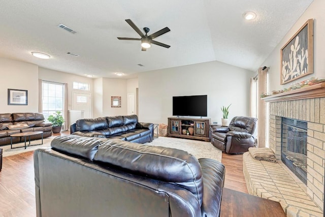 602 Totem Trl, Harker Heights, TX 76548 - living area with a ceiling fan, light wood finished floors, a fireplace, lofted ceiling, and a textured ceiling