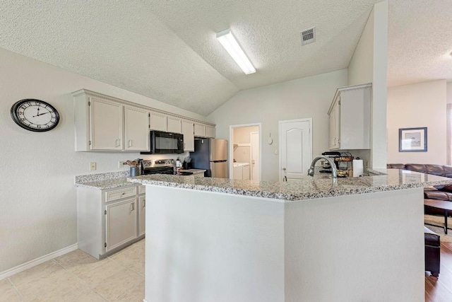602 Totem Trl, Harker Heights, TX 76548 - kitchen with stainless steel appliances, a peninsula, lofted ceiling, light stone counters, and a textured ceiling