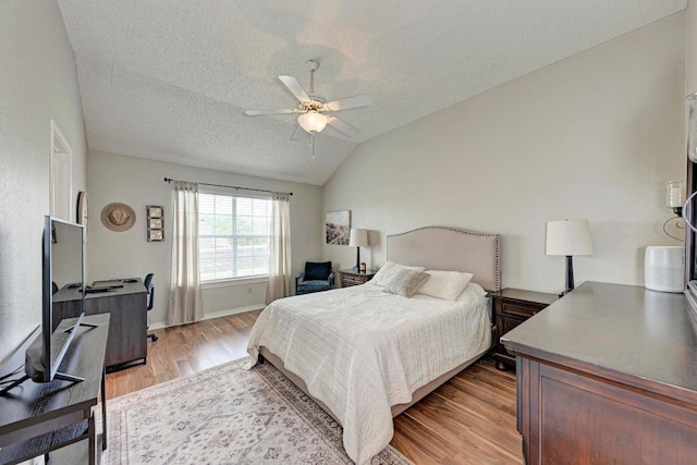 602 Totem Trl, Harker Heights, TX 76548 - bedroom featuring light wood-type flooring, lofted ceiling, a textured ceiling, and a ceiling fan