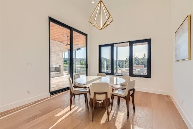 dining space featuring light wood-type flooring and baseboards