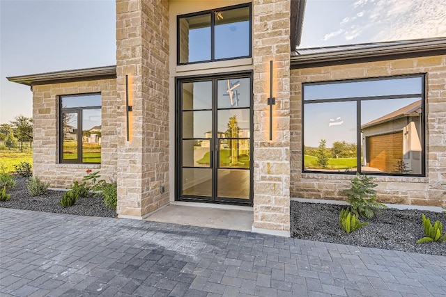 doorway to property featuring stone siding