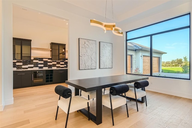 dining space with light wood-style floors and baseboards