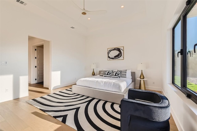 bedroom with light wood-style flooring, baseboards, and recessed lighting