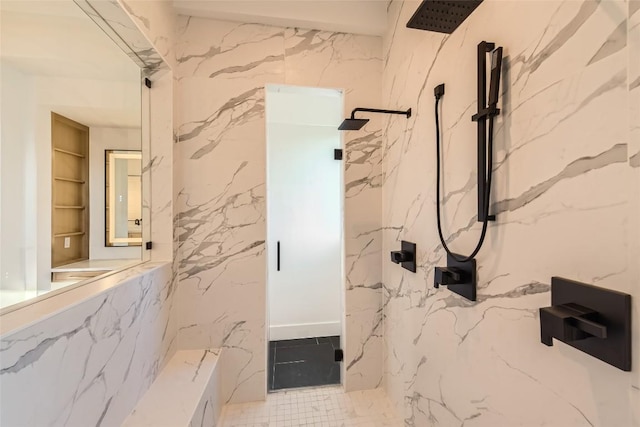 bathroom with a marble finish shower, built in shelves, and stone wall