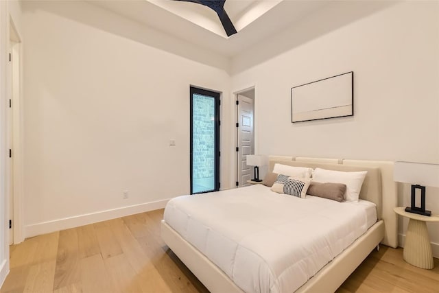 bedroom with light wood-style flooring and baseboards