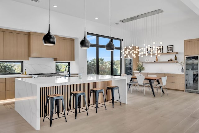 420 Waters Edge Cv, Dripping Springs, TX 78620 - kitchen with a sink, light brown cabinets, plenty of natural light, modern cabinets, and fridge