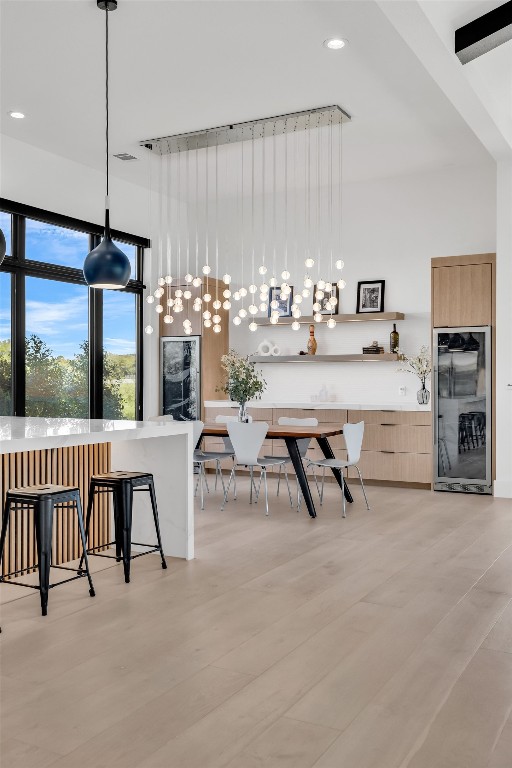 420 Waters Edge Cv, Dripping Springs, TX 78620 - interior space with open shelves, light wood finished floors, modern cabinets, and refrigerator