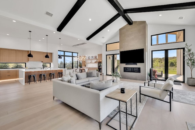 420 Waters Edge Cv, Dripping Springs, TX 78620 - living area featuring high vaulted ceiling, beam ceiling, light wood-type flooring, visible vents, and recessed lighting