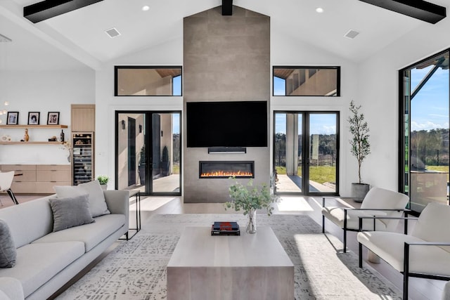 420 Waters Edge Cv, Dripping Springs, TX 78620 - living area featuring a large fireplace, high vaulted ceiling, visible vents, and wood finished floors