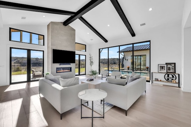 420 Waters Edge Cv, Dripping Springs, TX 78620 - living room with a large fireplace, visible vents, beamed ceiling, and high vaulted ceiling