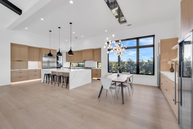 420 Waters Edge Cv, Dripping Springs, TX 78620 - dining area with a towering ceiling, visible vents, recessed lighting, a chandelier, and light wood finished floors