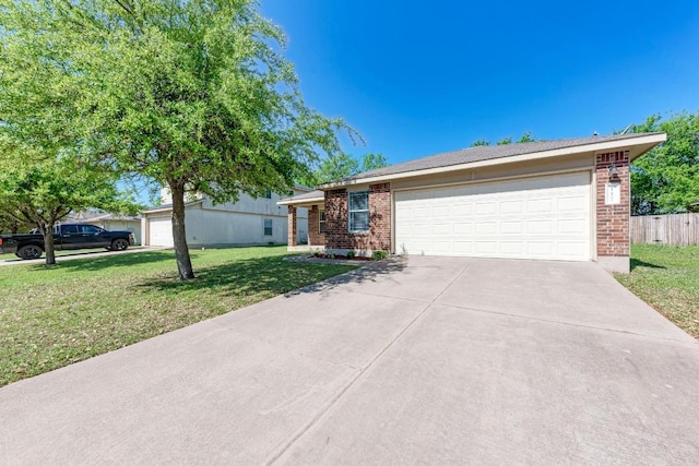 117 Easy St, Hutto, TX 78634 - ranch-style house with brick siding, driveway, and an attached garage