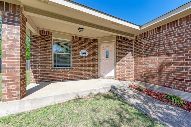 117 Easy St, Hutto, TX 78634 - doorway to property with brick siding