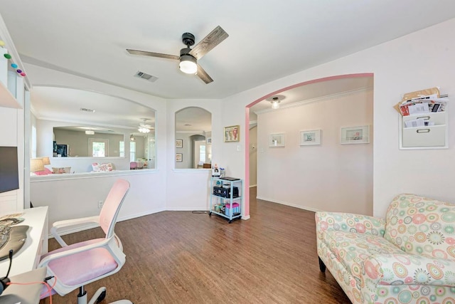 117 Easy St, Hutto, TX 78634 - home office featuring ceiling fan, arched walkways, wood finished floors, and baseboards