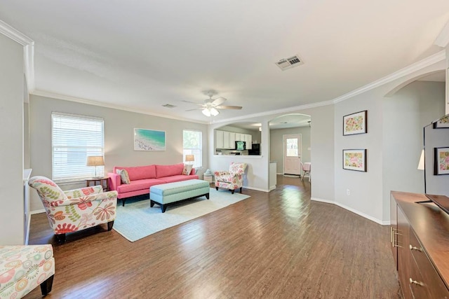 117 Easy St, Hutto, TX 78634 - living area with arched walkways, dark wood-style floors, crown molding, a ceiling fan, and baseboards