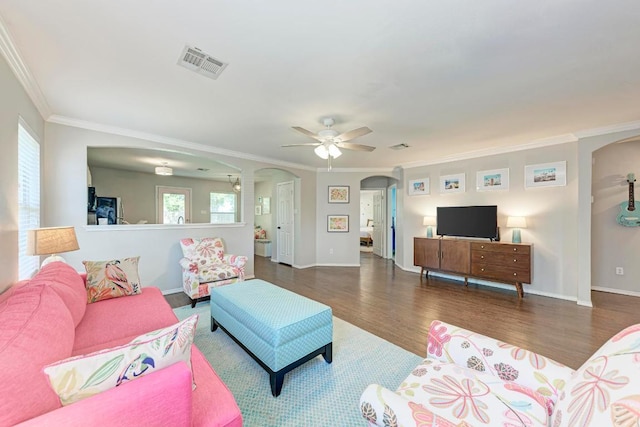 117 Easy St, Hutto, TX 78634 - living area with arched walkways, ornamental molding, wood finished floors, a ceiling fan, and baseboards