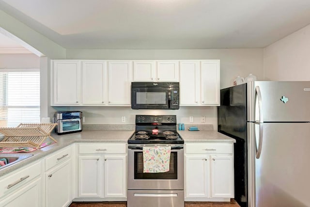 117 Easy St, Hutto, TX 78634 - kitchen featuring appliances with stainless steel finishes, white cabinetry, and light countertops