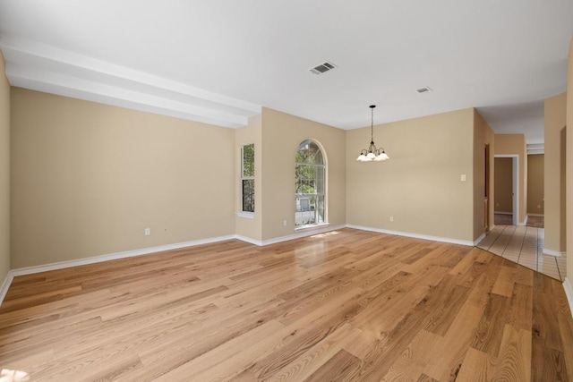 2300 Nevins Cv, Lago Vista, TX 78645 - spare room featuring a chandelier and light wood-style floors