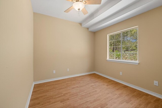 empty room with ceiling fan, baseboards, and wood finished floors