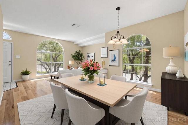 2300 Nevins Cv, Lago Vista, TX 78645 - dining area with a chandelier and light wood-type flooring