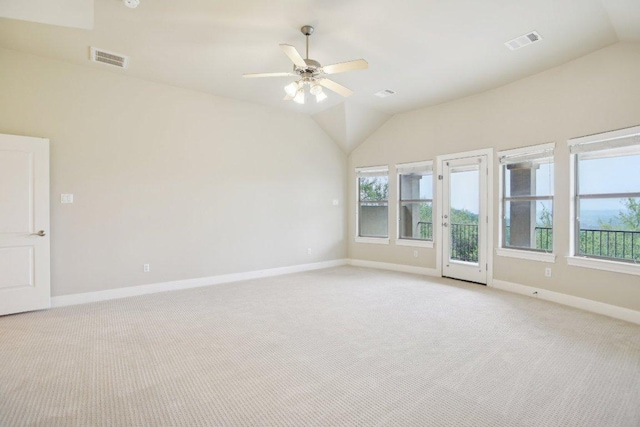 spare room featuring vaulted ceiling, visible vents, and light colored carpet