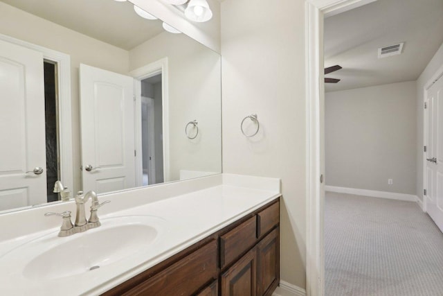 bathroom featuring visible vents, vanity, baseboards, and a ceiling fan