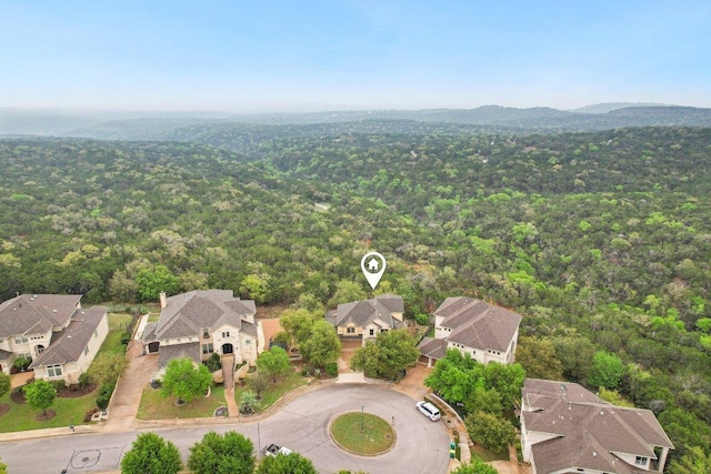 birds eye view of property featuring a forest view and a residential view