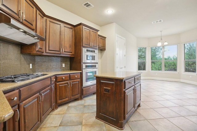kitchen featuring light tile patterned flooring, visible vents, decorative backsplash, under cabinet range hood, and appliances with stainless steel finishes