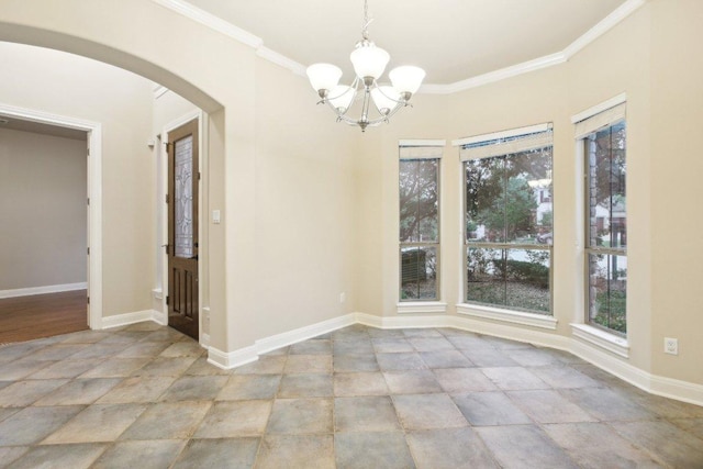 unfurnished dining area with an inviting chandelier, stone finish floor, arched walkways, crown molding, and baseboards