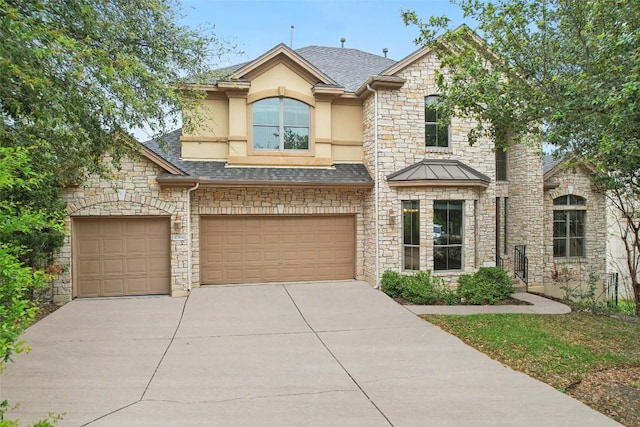 view of front of house featuring a garage, stone siding, concrete driveway, and a shingled roof