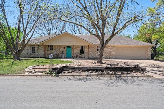 1604 Robb Ln, Round Rock, TX 78664 - view of front facade with a front yard, stone siding, a garage, concrete driveway, and roof with shingles