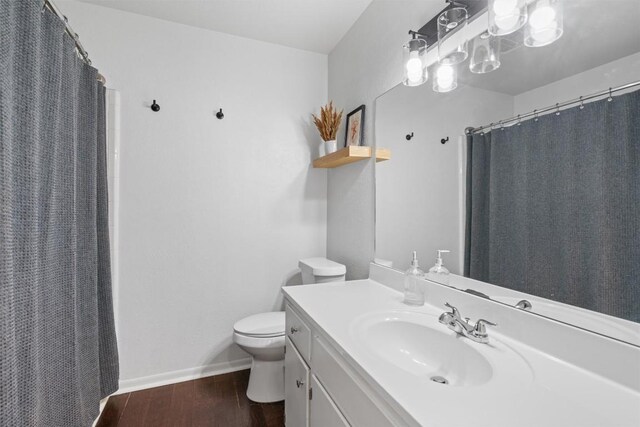 1604 Robb Ln, Round Rock, TX 78664 - bathroom with toilet, curtained shower, vanity, and wood finished floors