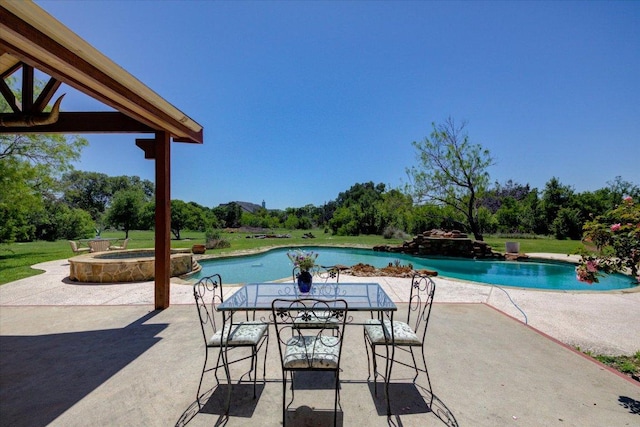 200 Matzig Cv, Buda, TX 78610 - outdoor pool with a patio area, an in-ground hot tub, and view of wooded area