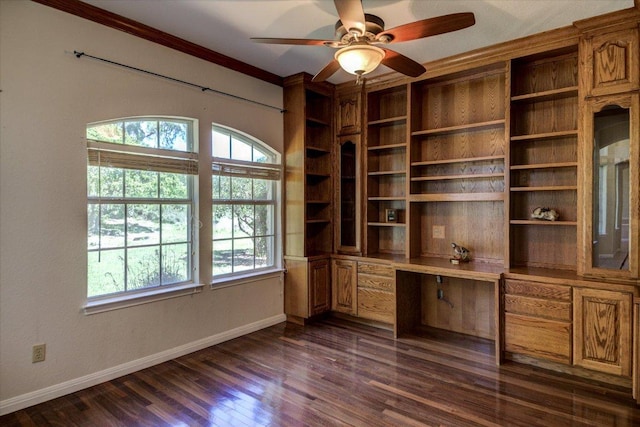 200 Matzig Cv, Buda, TX 78610 - unfurnished office featuring built in desk, dark wood-type flooring, ornamental molding, baseboards, and ceiling fan