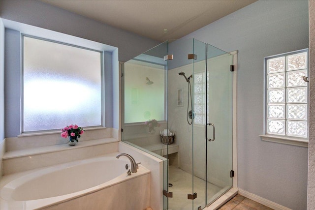 200 Matzig Cv, Buda, TX 78610 - bathroom with a bath, a stall shower, healthy amount of natural light, and tile patterned floors