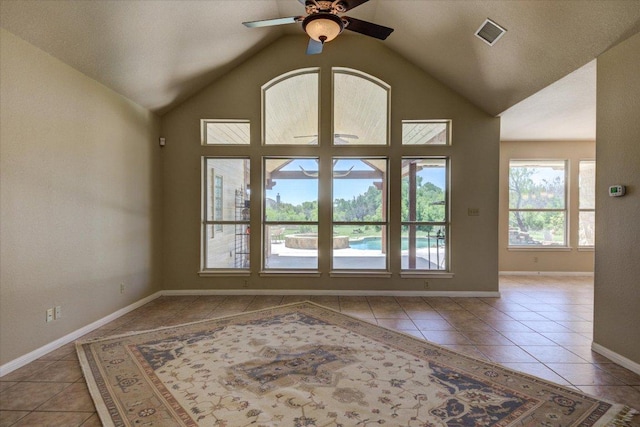 200 Matzig Cv, Buda, TX 78610 - empty room featuring tile patterned floors, a ceiling fan, vaulted ceiling, and baseboards