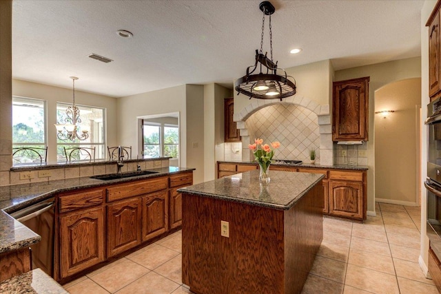 200 Matzig Cv, Buda, TX 78610 - kitchen with a sink, backsplash, a center island, healthy amount of natural light, and recessed lighting