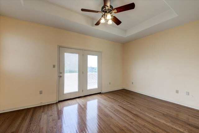 200 Matzig Cv, Buda, TX 78610 - unfurnished room with wood finished floors, a tray ceiling, ceiling fan, and baseboards