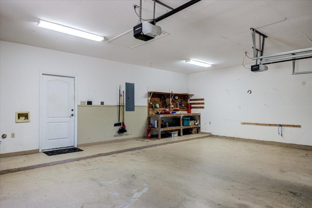 200 Matzig Cv, Buda, TX 78610 - garage featuring electric panel, a garage door opener, and a workshop area