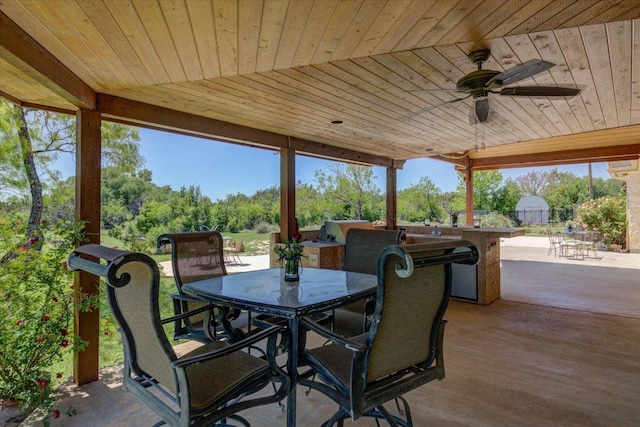 200 Matzig Cv, Buda, TX 78610 - view of patio featuring outdoor dining space, a ceiling fan, and view of wooded area