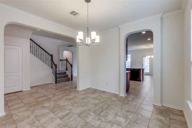 339 Alamosa Dr, Georgetown, TX 78626 - empty room featuring a chandelier, arched walkways, ornamental molding, and stairway