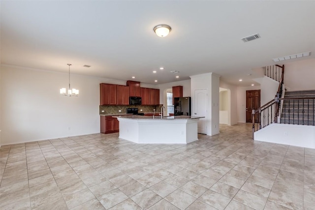 339 Alamosa Dr, Georgetown, TX 78626 - kitchen with black appliances, open floor plan, a chandelier, decorative backsplash, and light countertops