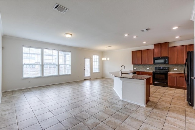 339 Alamosa Dr, Georgetown, TX 78626 - kitchen featuring black appliances, crown molding, a chandelier, light tile patterned flooring, and decorative backsplash