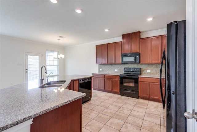 339 Alamosa Dr, Georgetown, TX 78626 - kitchen featuring black appliances, decorative backsplash, light tile patterned floors, brown cabinets, and a chandelier