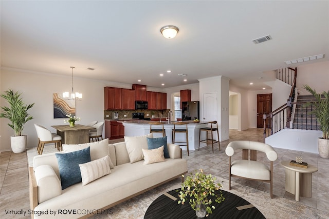 339 Alamosa Dr, Georgetown, TX 78626 - living area with a chandelier, stairway, recessed lighting, and crown molding