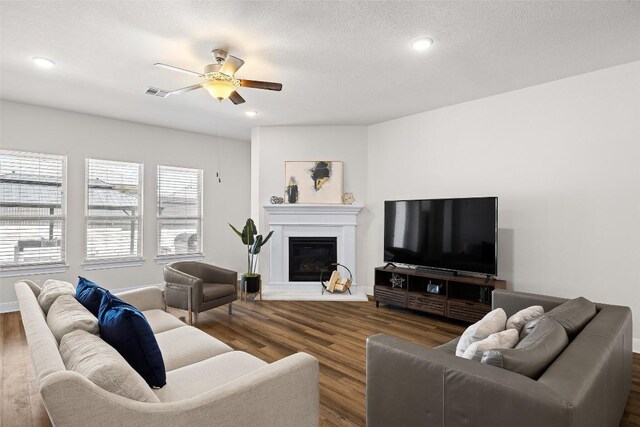 124 Adina Dr, Dripping Springs, TX 78620 - living area with ceiling fan, dark wood-style floors, a glass covered fireplace, and recessed lighting
